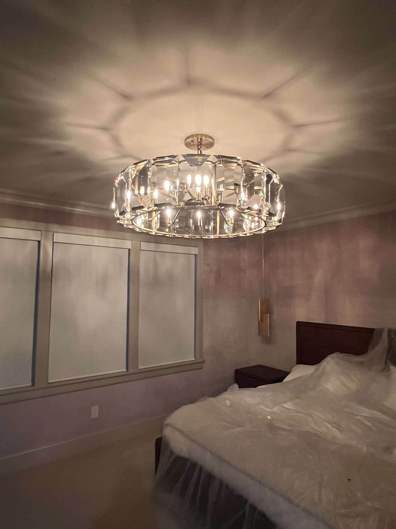 Decorative chandelier installed in a bedroom