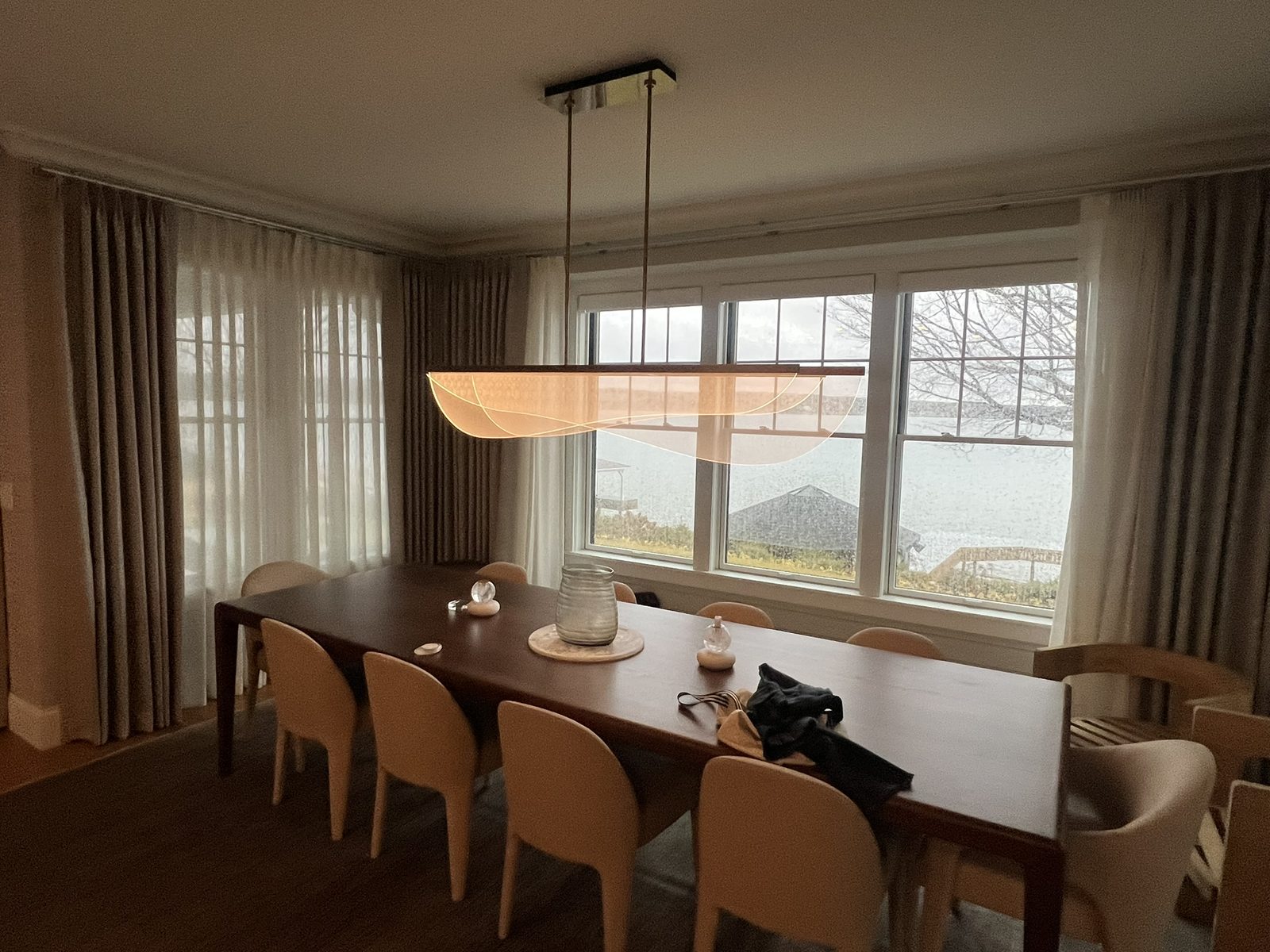 Pendant lighting over a dining area in a lakeside home