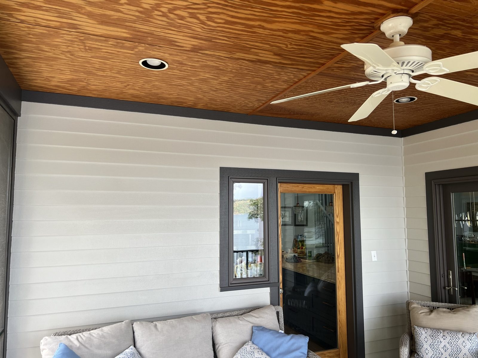 Recessed lighting and ceiling fan in a lakeside living room