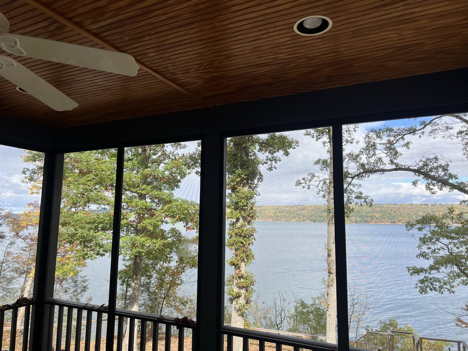 Screened porch with recessed lighting and lake view