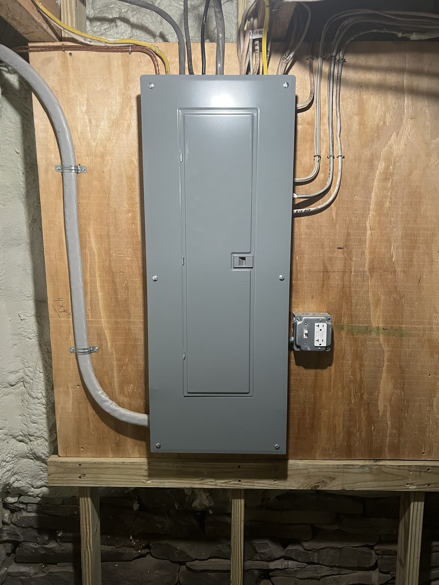 Reorganized breaker panel with clean conduit after rework